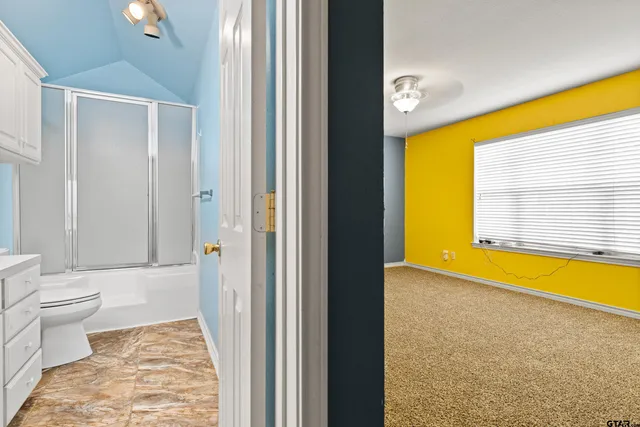 a bathroom with a bathtub and a toilet