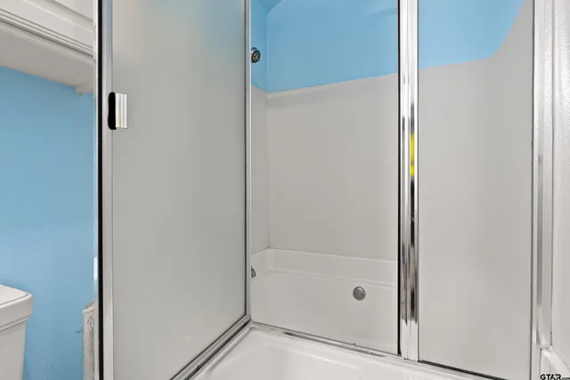a bathroom with a glass shower door
