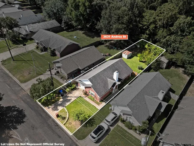 an aerial view of a tennis ground and a cars park side of the road