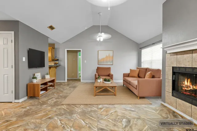 a living room with furniture and a flat screen tv