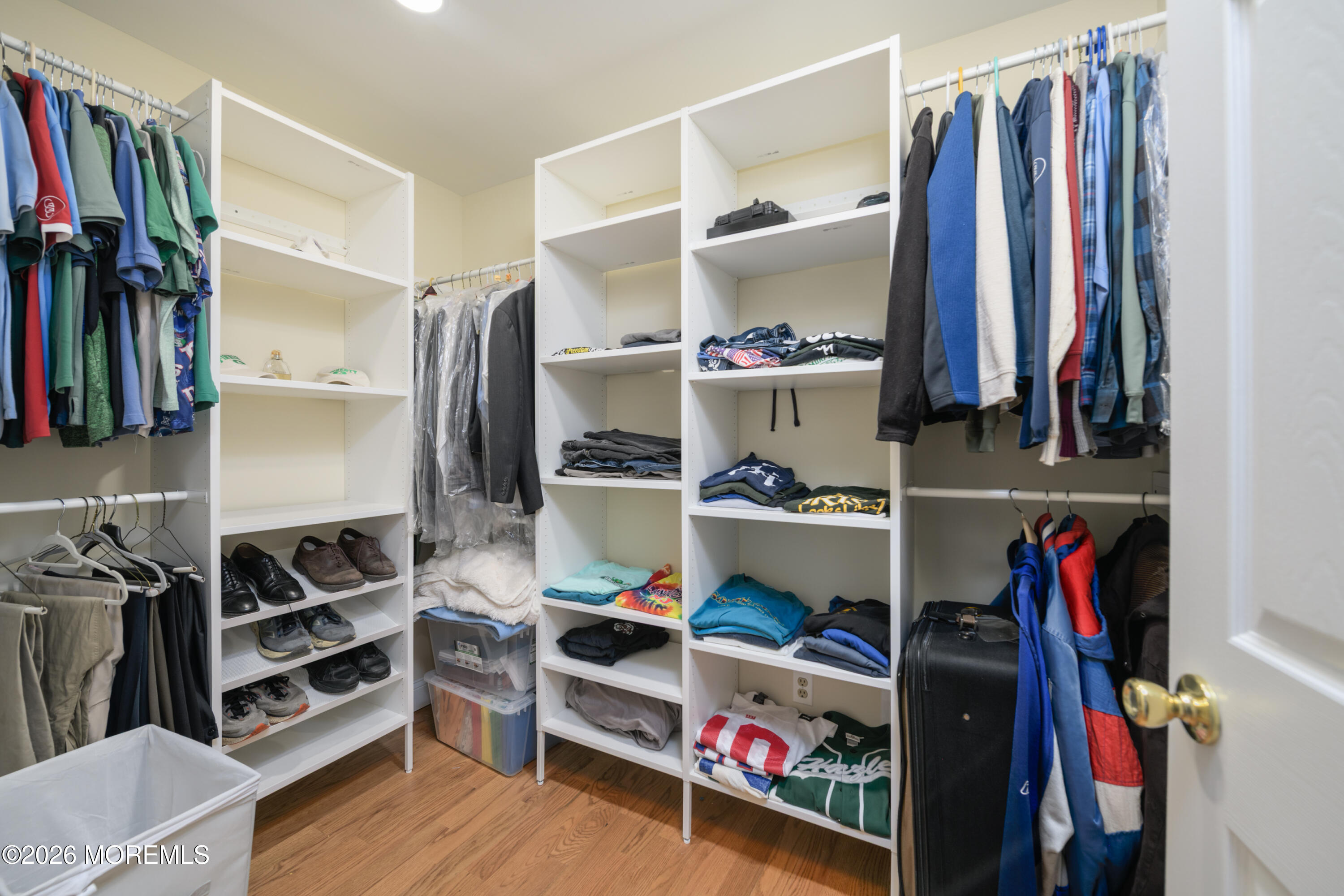 4 Colgate Court Hazlet, NJ 07730 - Photo 20 of 43 a view of walk in closet with clothes and shoes