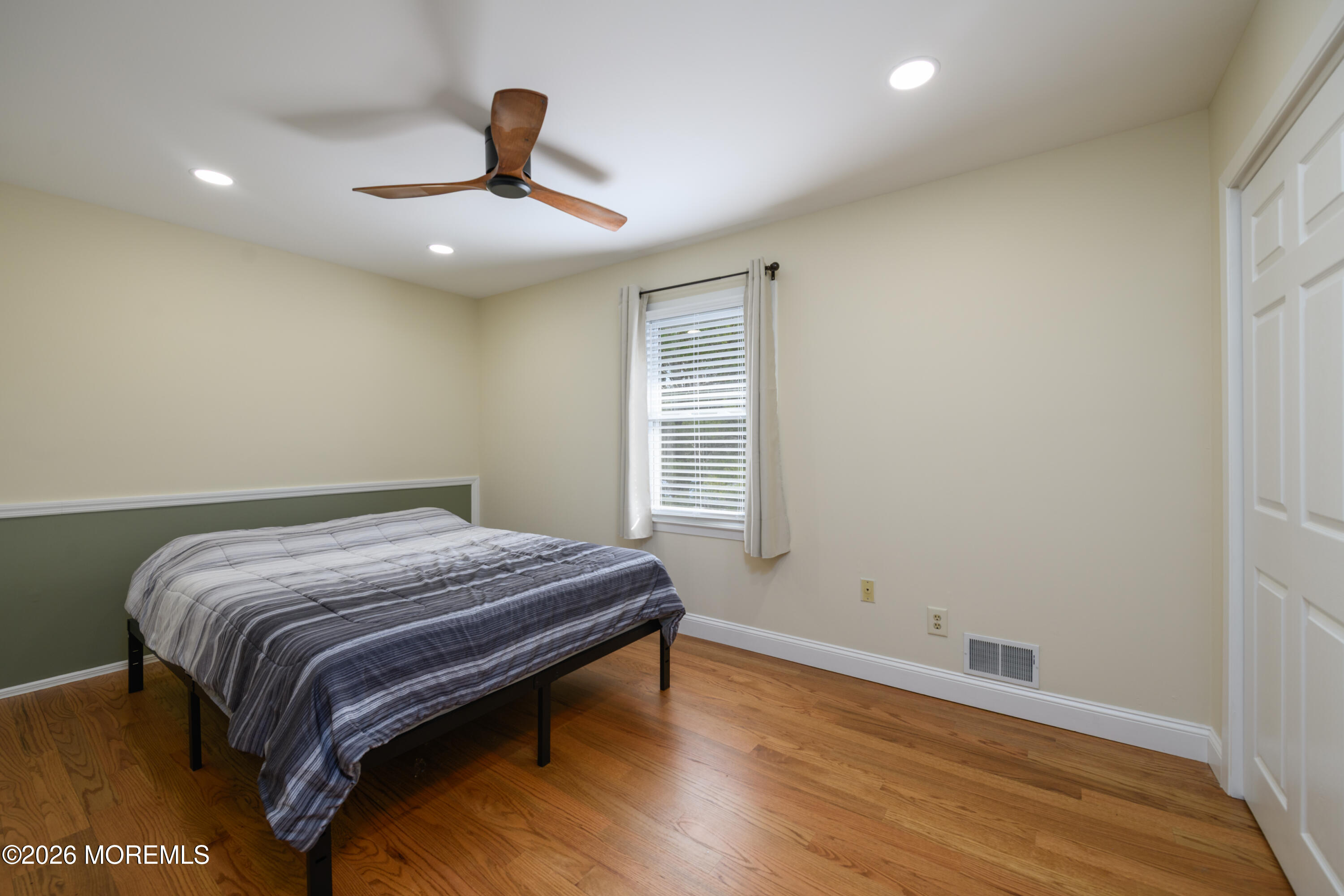 4 Colgate Court Hazlet, NJ 07730 - Photo 28 of 43 a bedroom with a bed and wooden floor