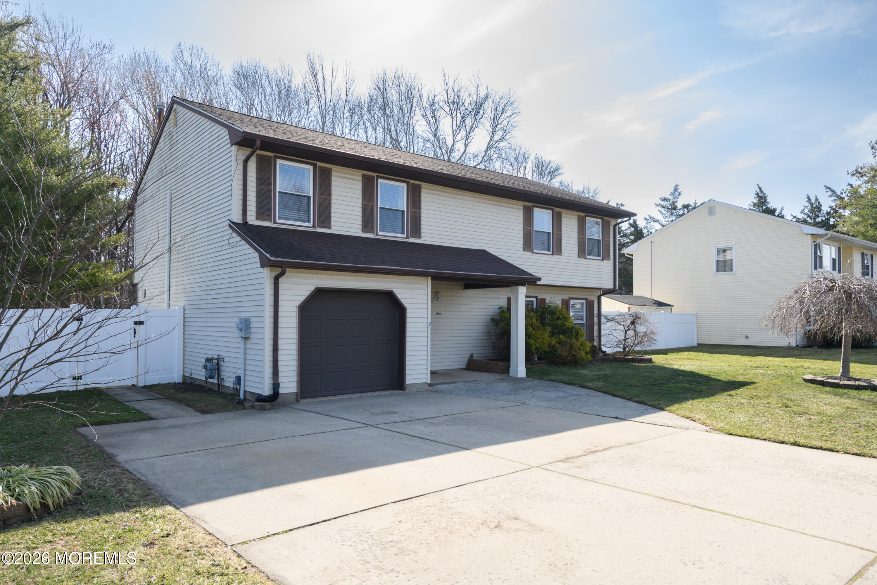 4 Colgate Court Hazlet, NJ 07730 - Photo 39 of 43 a front view of a house with a yard and garage