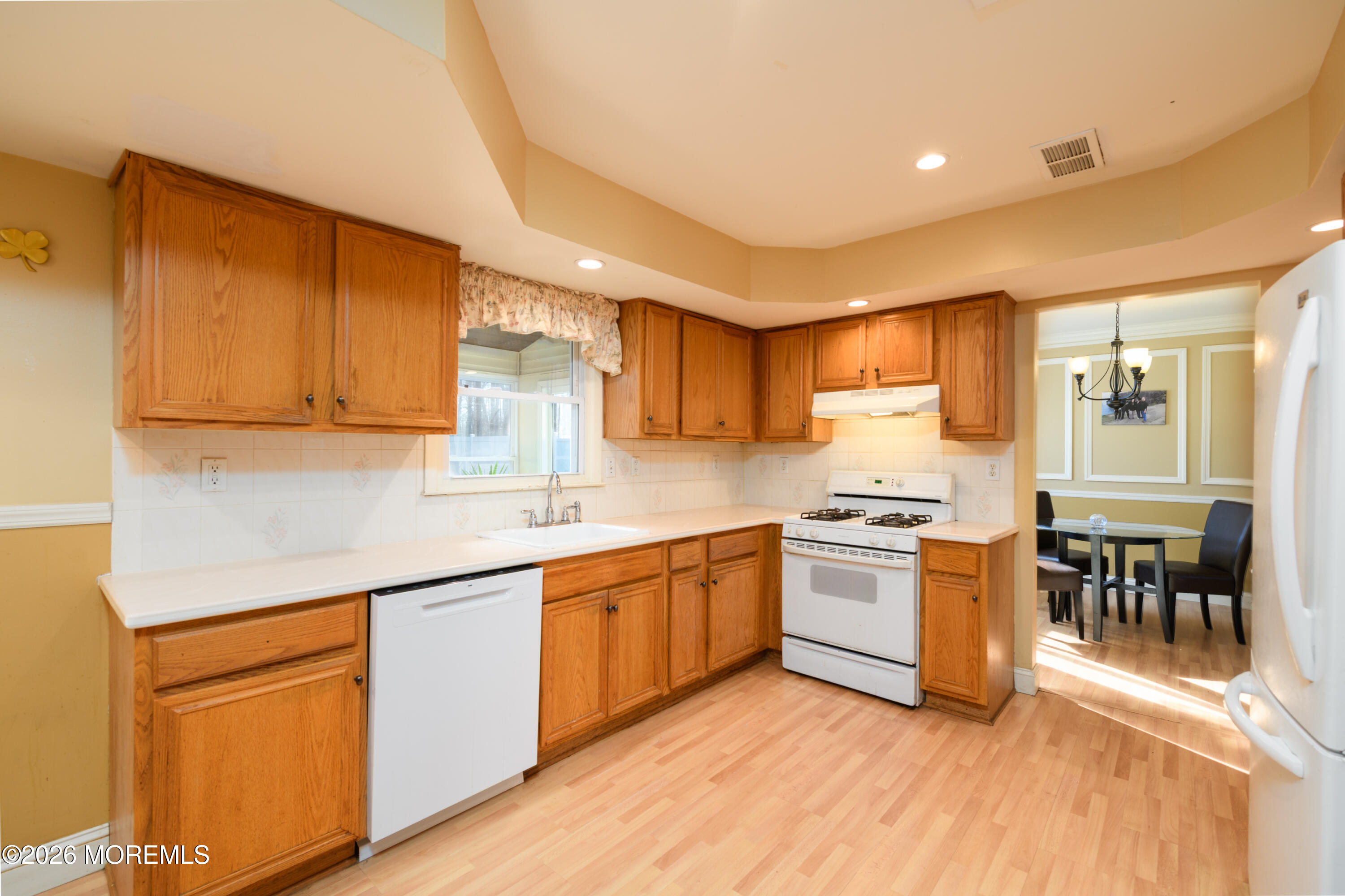 4 Colgate Court Hazlet, NJ 07730 - Photo 8 of 43 a kitchen with stainless steel appliances granite countertop wooden cabinets a sink a stove a dining table and chairs