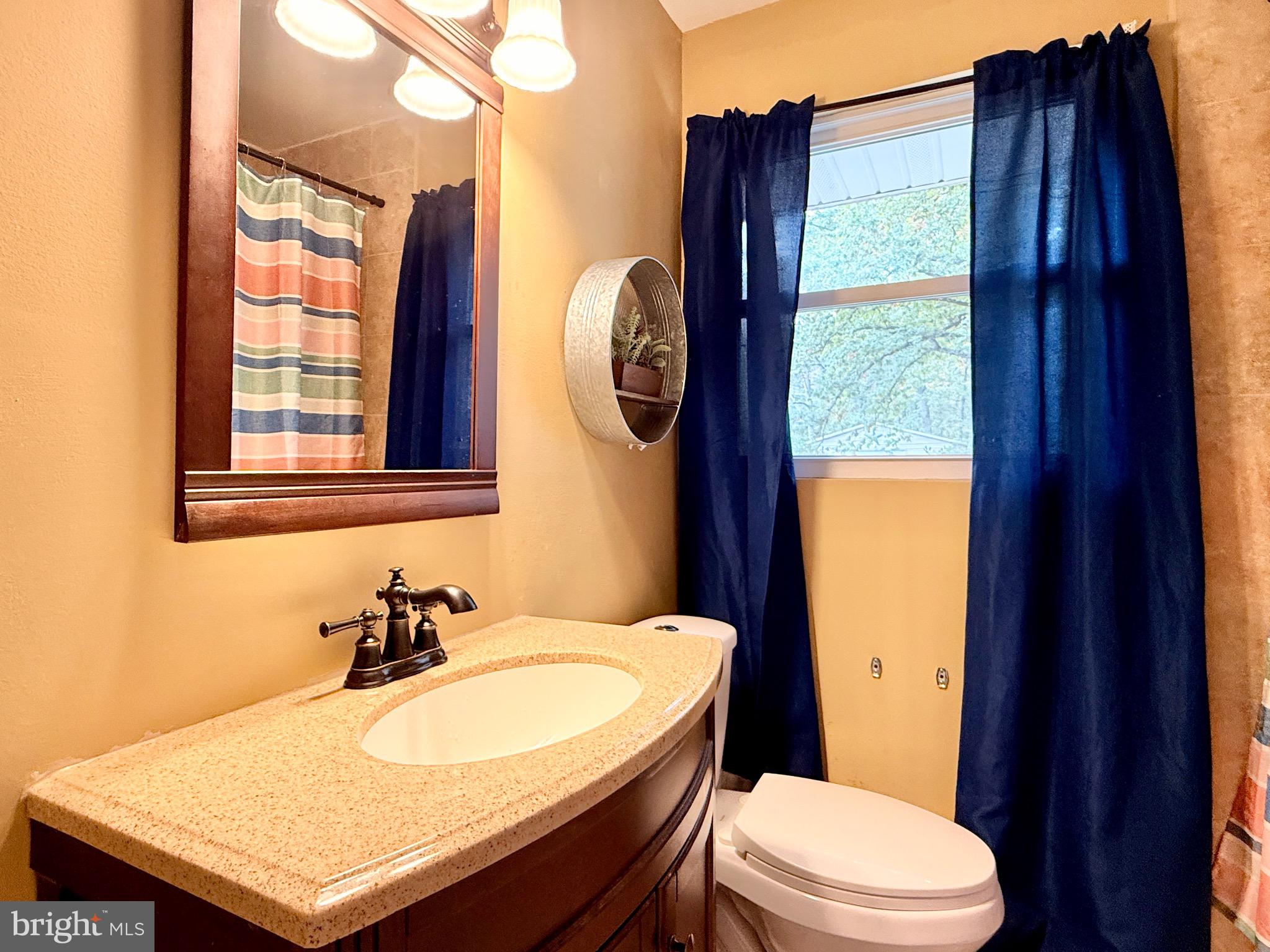 1325 Janvier Road Williamstown, NJ 08094 - Photo 19 of 32 a bathroom with a toilet sink and mirror