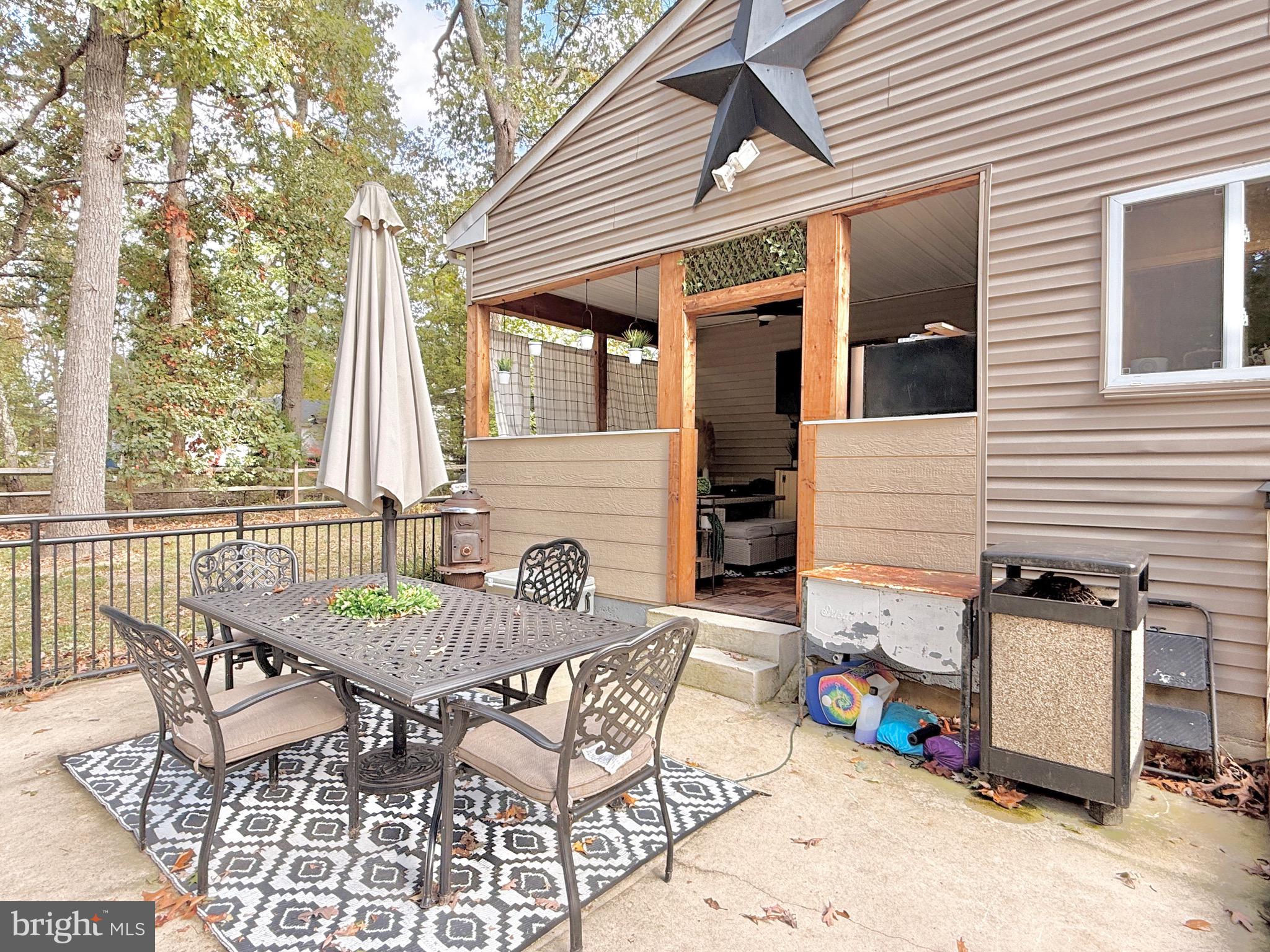 1325 Janvier Road Williamstown, NJ 08094 - Photo 26 of 32 a view of a patio with table and chairs and wooden fence