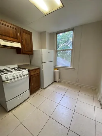 a kitchen with a stove a sink and a refrigerator