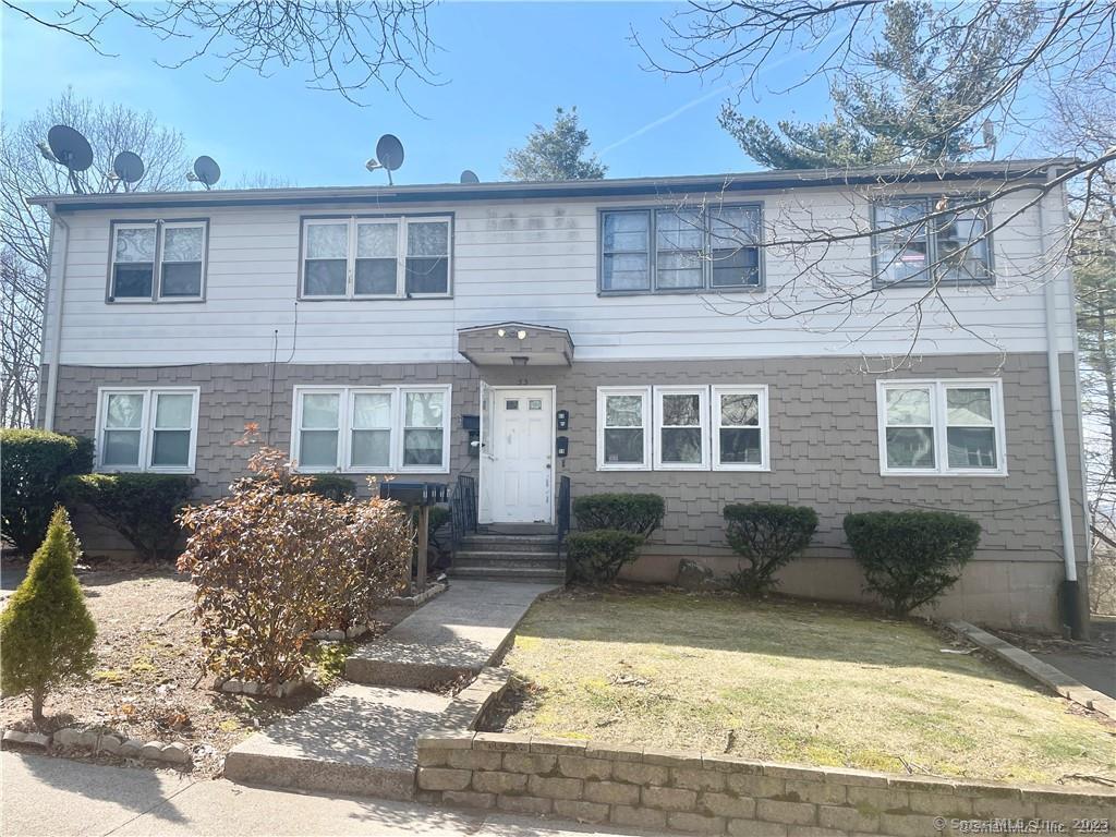 55 Oak Ridge Drive, Unit 60 New Haven, CT 06513 - Photo 1 of 16 a front view of a house with a yard