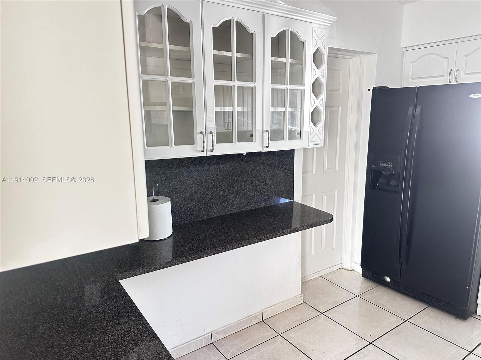 2914 Southwest 92nd Court Miami, FL 33165 - Photo 11 of 39 a kitchen with white cabinets and a refrigerator