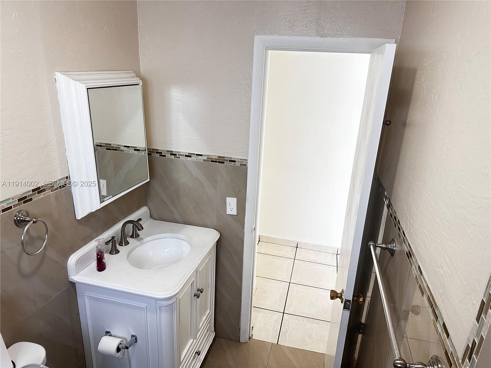 2914 Southwest 92nd Court Miami, FL 33165 - Photo 16 of 37 a bathroom with a sink a mirror and vanity