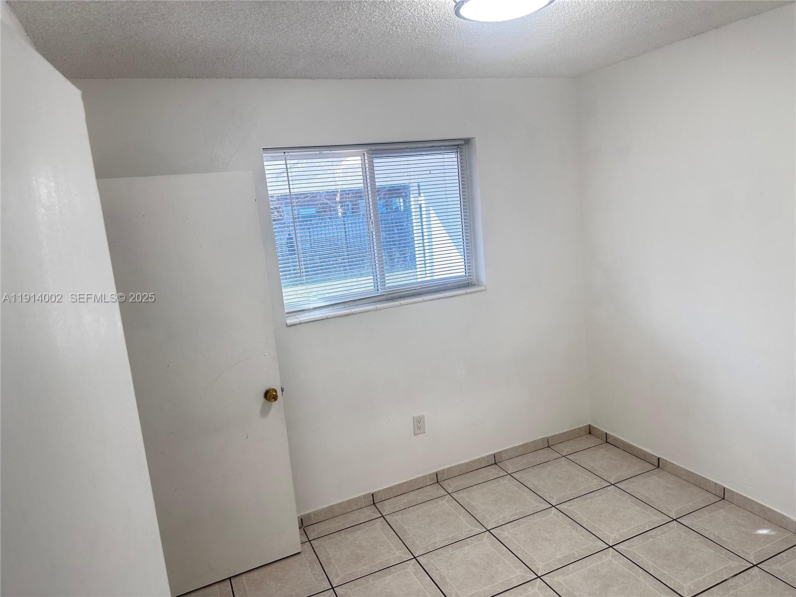 2914 Southwest 92nd Court Miami, FL 33165 - Photo 17 of 37 a view of an empty room with windows