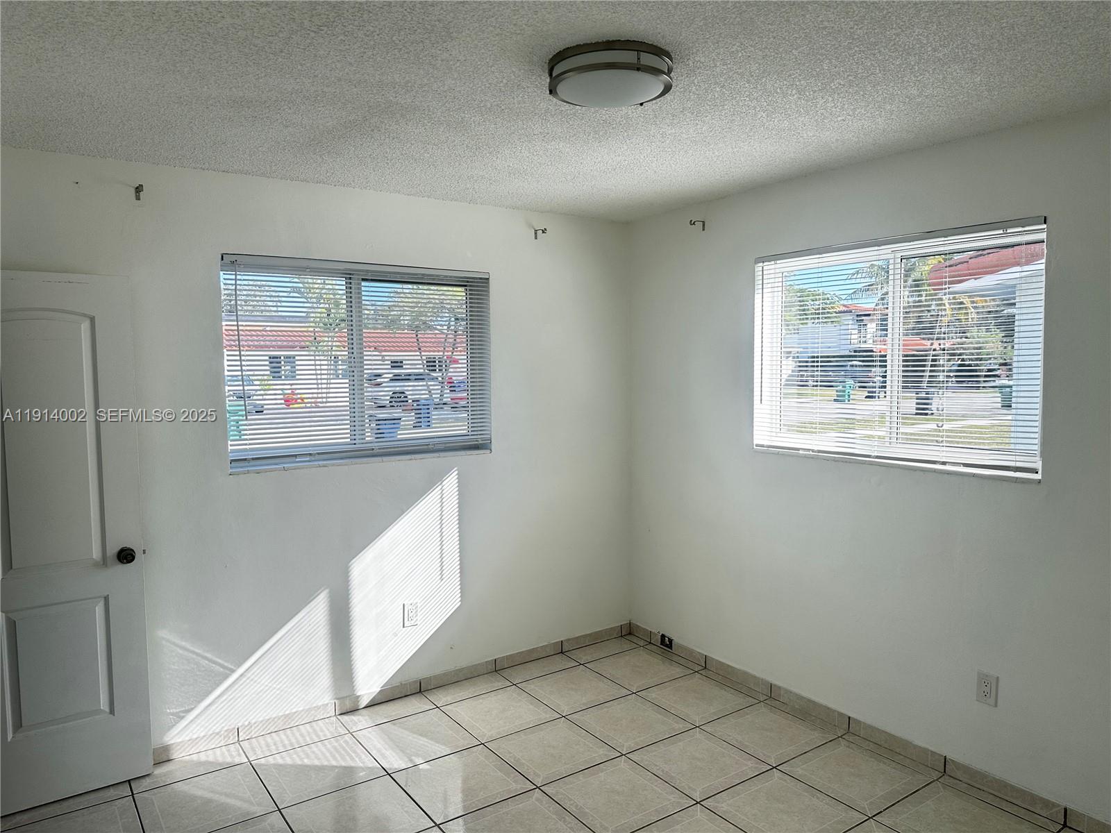 2914 Southwest 92nd Court Miami, FL 33165 - Photo 19 of 37 a view of an empty room with a window