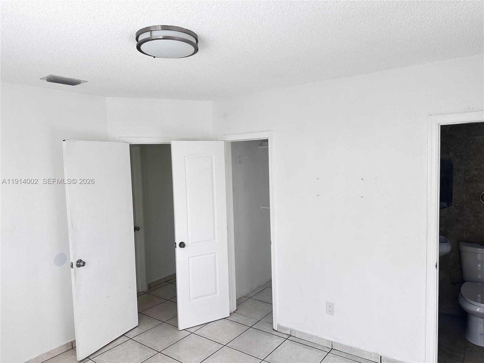 2914 Southwest 92nd Court Miami, FL 33165 - Photo 21 of 39 a view of a room with rack on the wall
