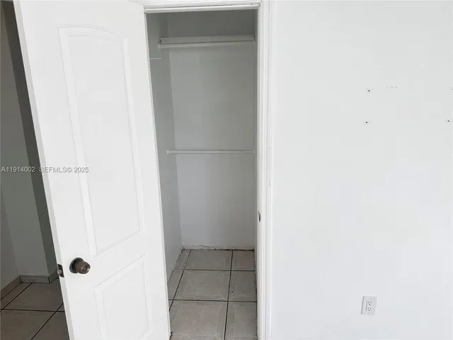 a kitchen with granite countertop a sink a stove and cabinets