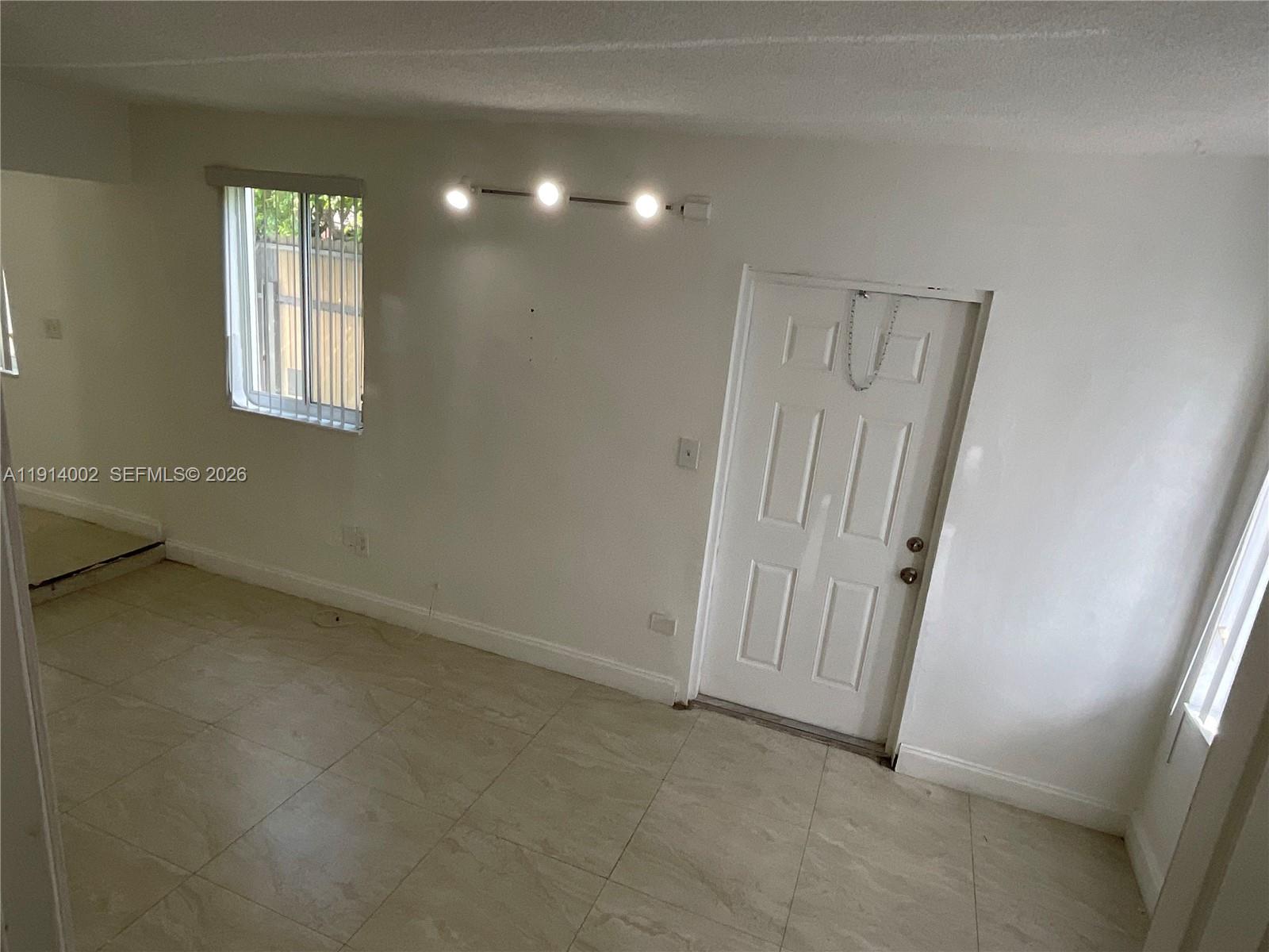 2914 Southwest 92nd Court Miami, FL 33165 - Photo 26 of 39 an empty room with windows and closet