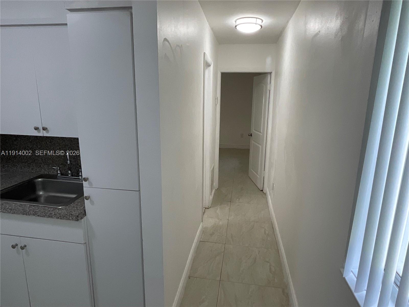2914 Southwest 92nd Court Miami, FL 33165 - Photo 30 of 39 a kitchen with a sink and a refrigerator