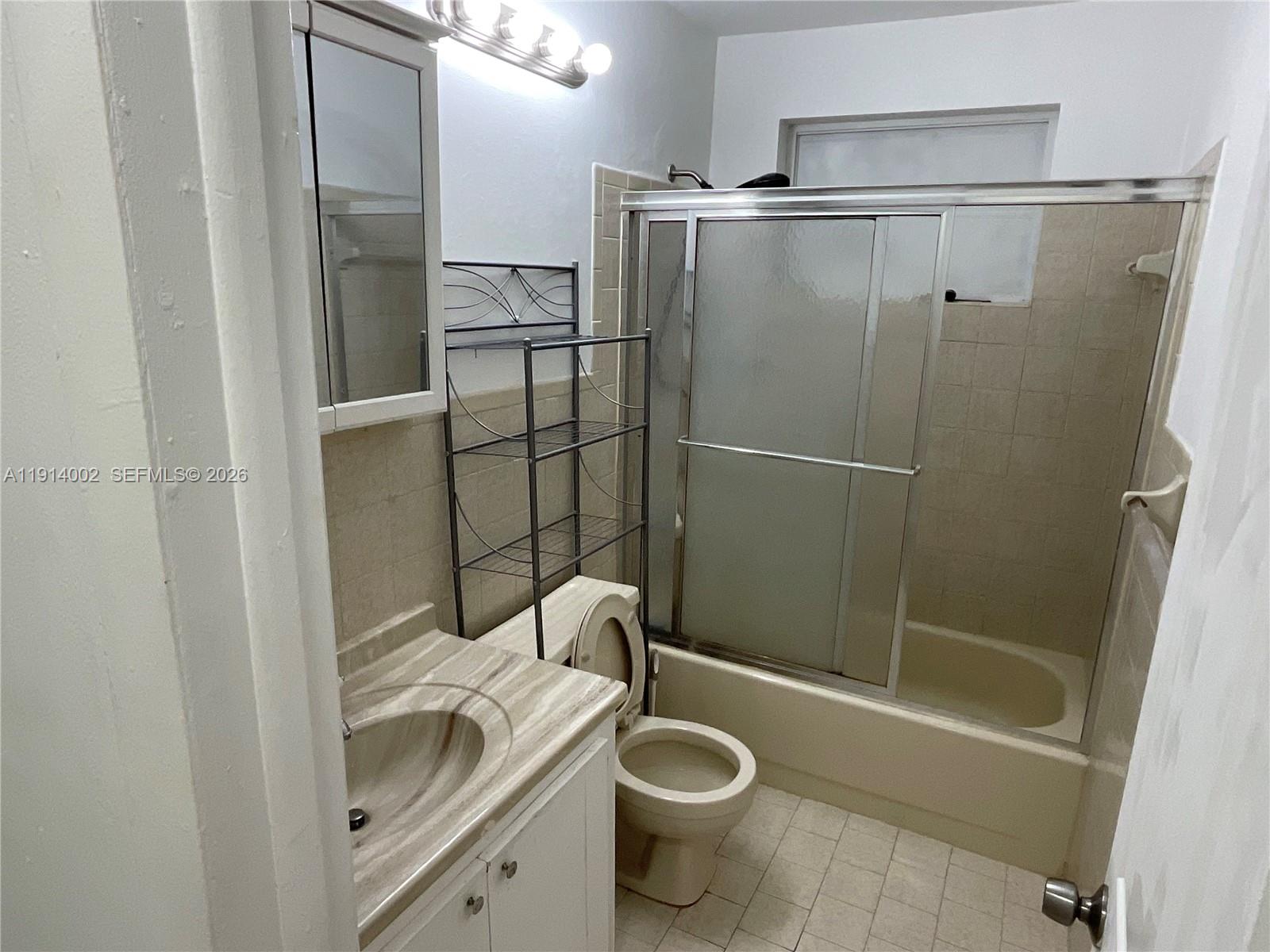 2914 Southwest 92nd Court Miami, FL 33165 - Photo 31 of 39 a bathroom with a shower a toilet and a sink