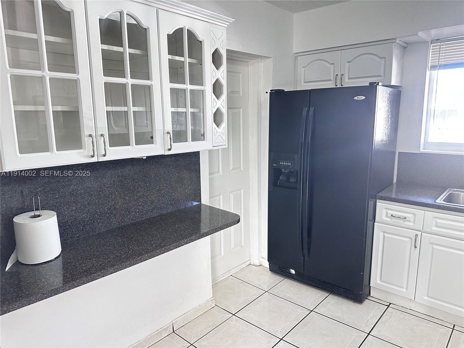 2914 Southwest 92nd Court Miami, FL 33165 - Photo 9 of 37 a kitchen with a sink and a refrigerator