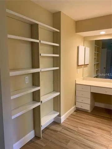 a view of walk in closet with empty racks