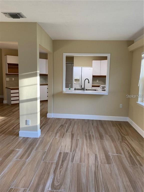 3090 Sunset Point Road Clearwater, FL 33759 - Photo 16 of 16 a view of a kitchen with wooden floor and electronic appliances