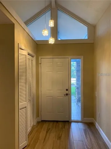 a view of a hallway with wooden floor