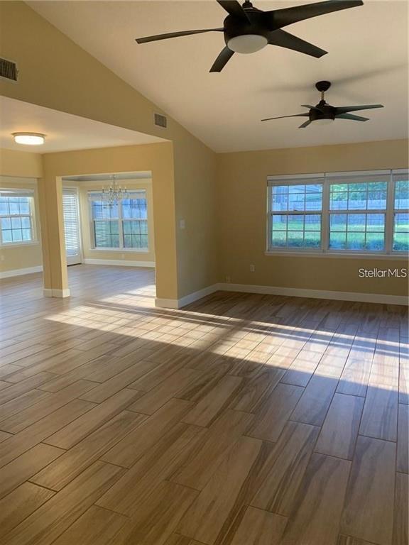 3090 Sunset Point Road Clearwater, FL 33759 - Photo 6 of 16 a view of empty room with wooden floor and fan