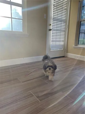 a room with wooden floor and a window