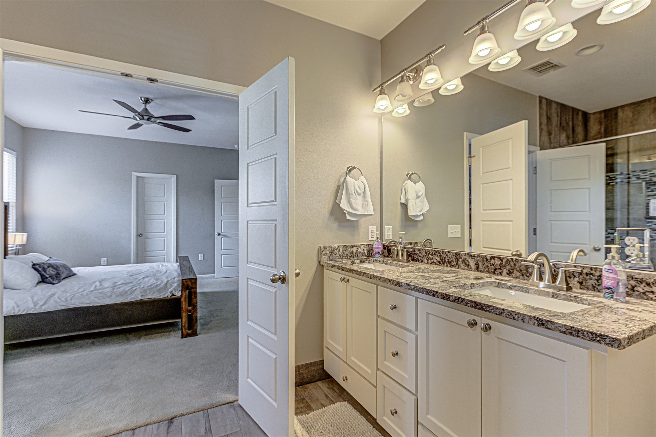 4809 Bolm Road Austin, TX 78702 - Photo 25 of 29 a en suite bathroom with a double vanity sink and a mirror