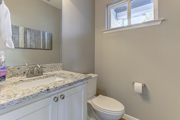 4809 Bolm Road Austin, TX 78702 - Photo 8 of 29 a bathroom with a granite countertop toilet sink and mirror