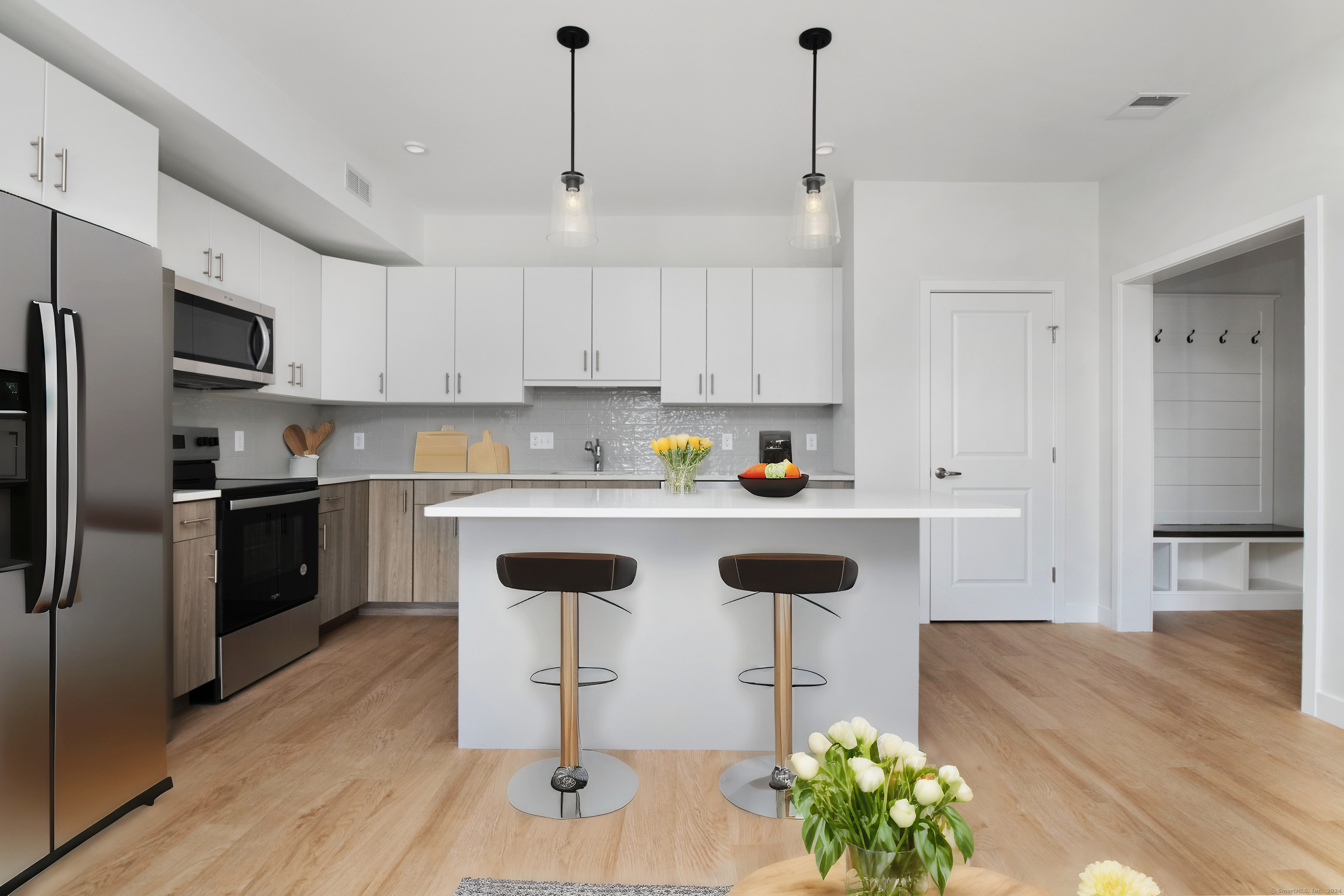 100 North Main Street, Unit 303 Bristol, CT 06010 - Photo 3 of 10 a kitchen with stainless steel appliances granite countertop a sink a stove a refrigerator and island with wooden floor