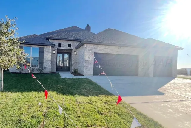 a white house with yard in front of it