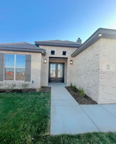 front view of a house with a yard