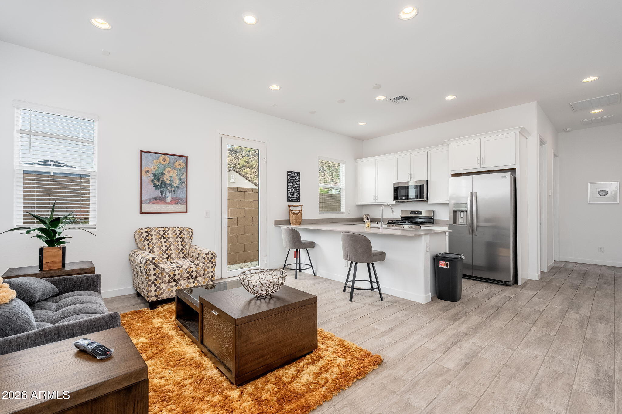 3272 West Peak View Road Phoenix, AZ 85083 - Photo 22 of 47 a living room with furniture and kitchen view
