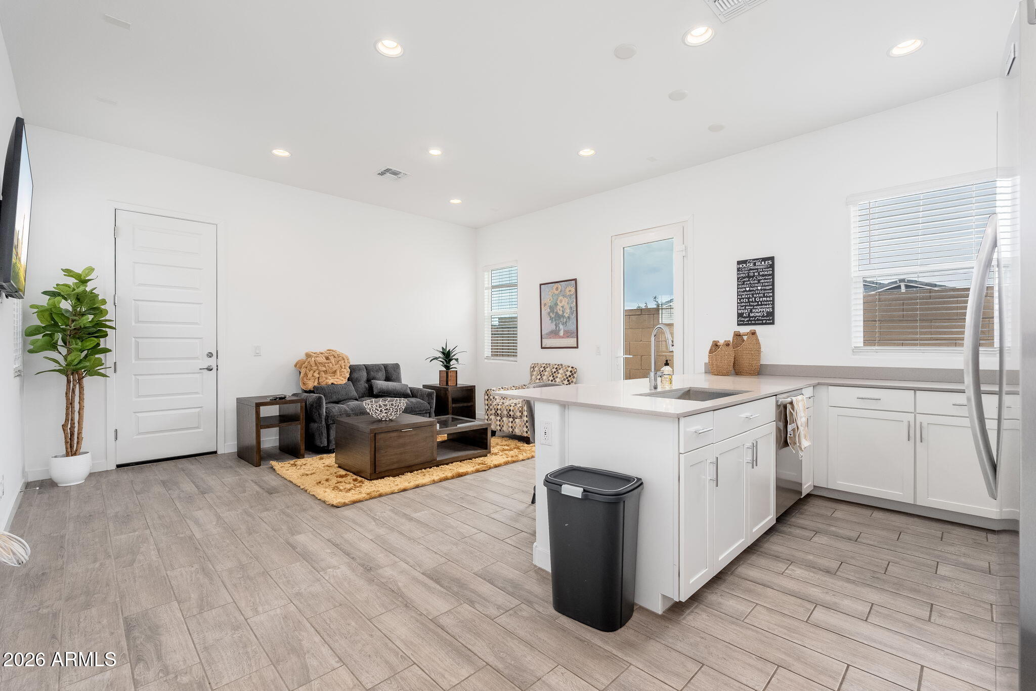3272 West Peak View Road Phoenix, AZ 85083 - Photo 24 of 47 a large white kitchen with a stove a sink dishwasher and a refrigerator with wooden floor