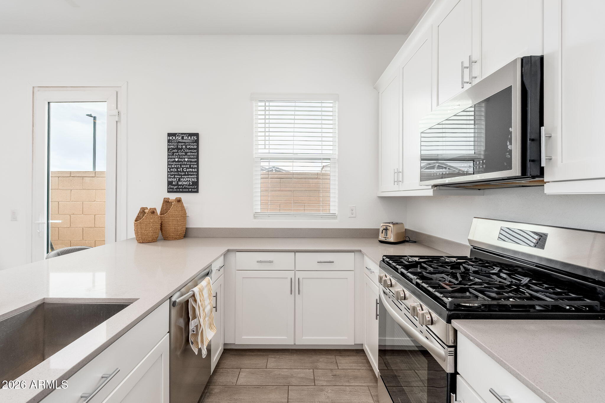 3272 West Peak View Road Phoenix, AZ 85083 - Photo 26 of 47 a kitchen with white cabinets and appliances
