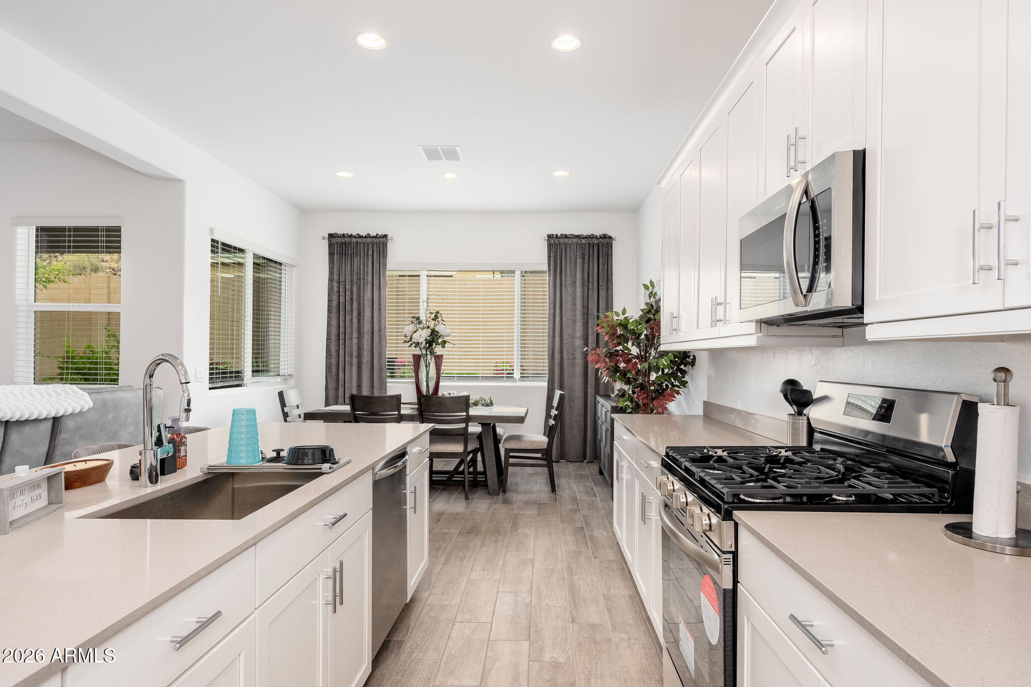 3272 West Peak View Road Phoenix, AZ 85083 - Photo 8 of 47 a kitchen with stainless steel appliances a stove a sink a refrigerator and cabinets