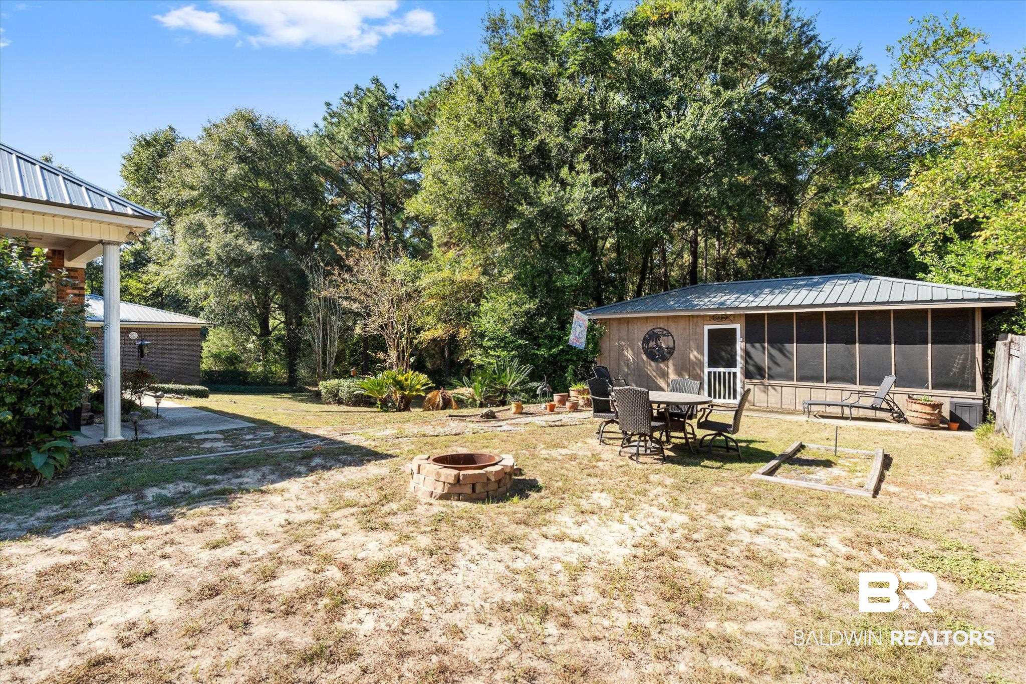 3651 Ching Dairy Loop Road South Mobile, AL 36618 - Photo 29 of 56 View of yard with a patio, a fire pit, and a sunroom