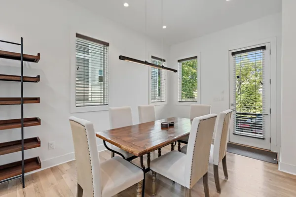 a view of a dining room with furniture and wooden floor