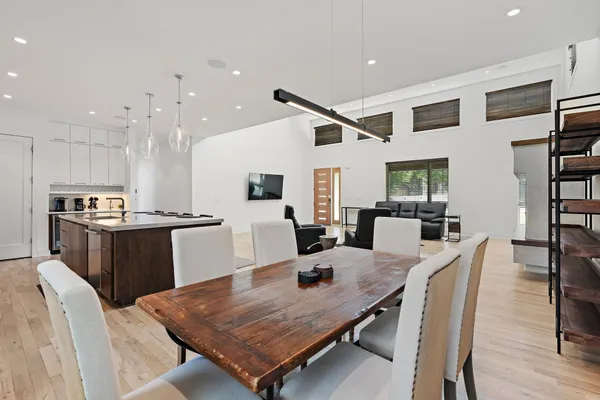 a kitchen with a table chairs refrigerator and microwave