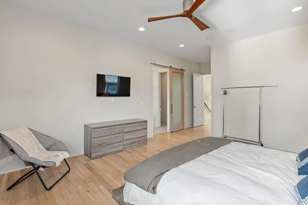 a bedroom with a bed and a chair