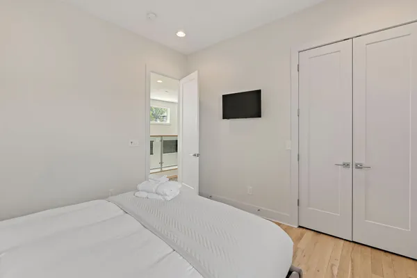 a bedroom with a bed and a tv