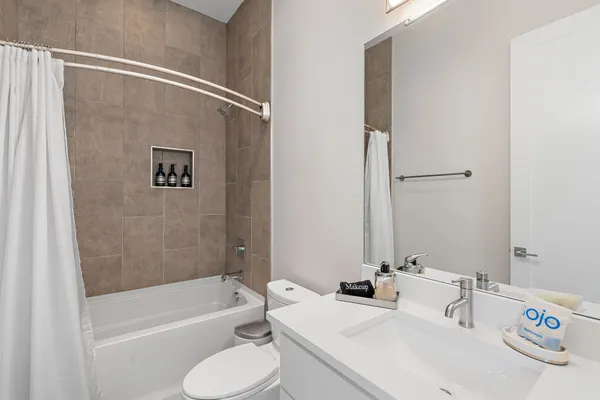 a bathroom with a sink a toilet and a bathtub