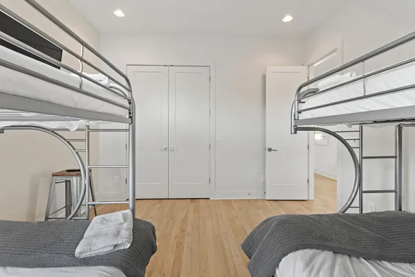 a living room with a bed and white cabinets