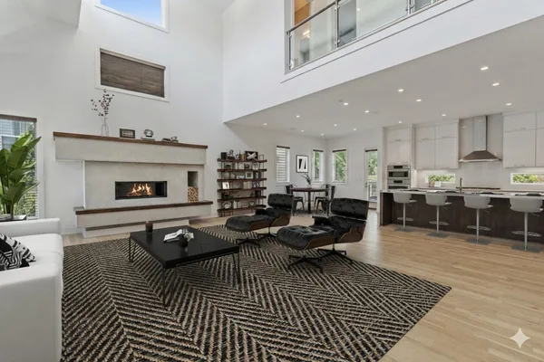 a living room with furniture a flat screen tv and kitchen view