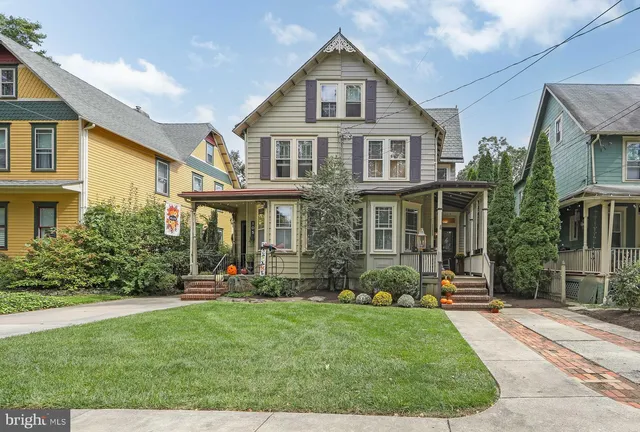 a front view of a house with a yard and porch