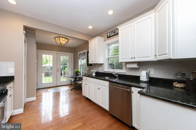 a kitchen with stainless steel appliances granite countertop a stove and a refrigerator