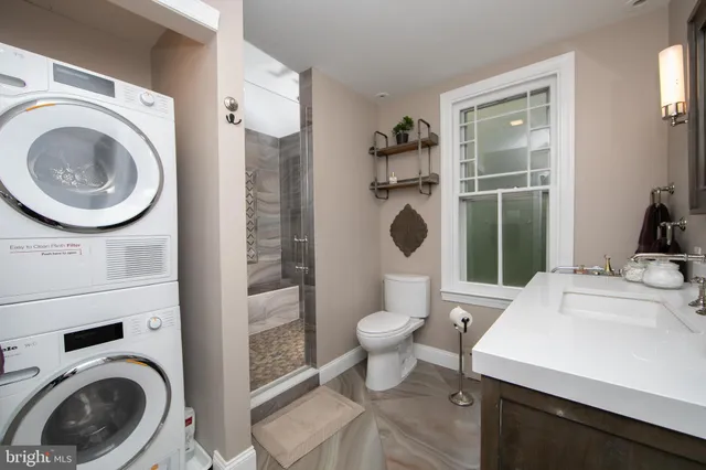 a bathroom with a sink a toilet and a mirror