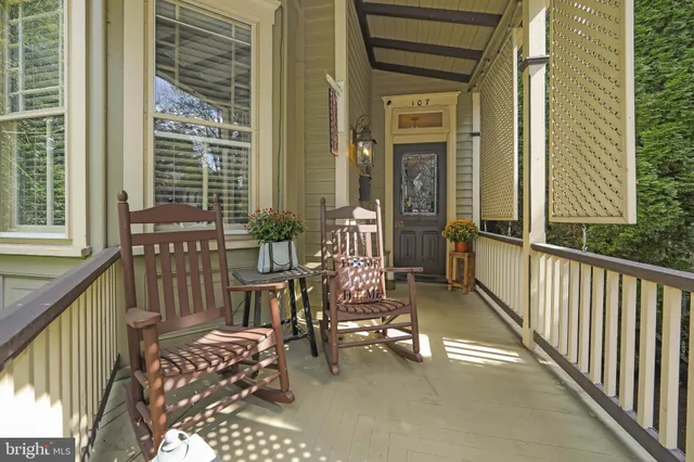 a view of balcony with two chairs and a potted plant