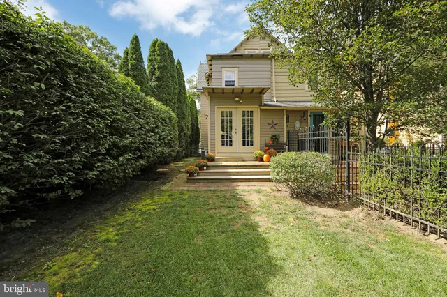 a view of a house with a yard and sitting area