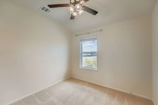 an empty room with windows and closet